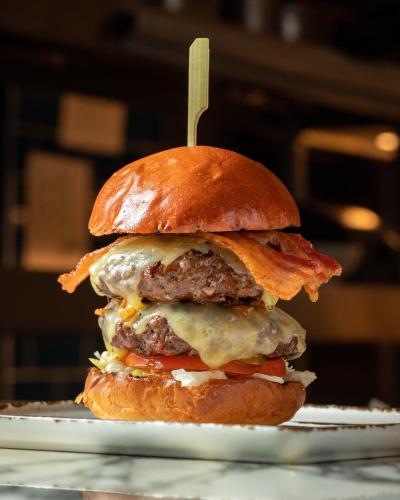 a hamburger on a bun with a toothpick in it at Harbour Hotel & Spa Guildford in Guildford