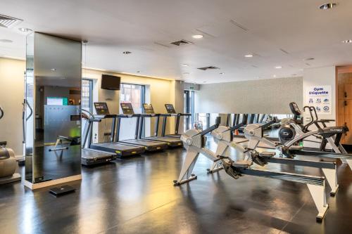 a gym with several treadmills and cardio machines at Harbour Hotel & Spa Guildford in Guildford