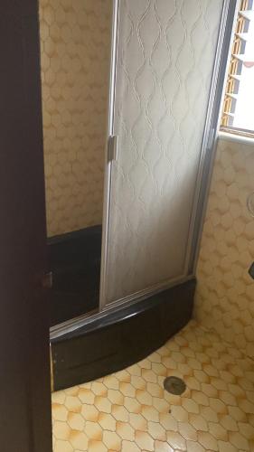 a bathroom with a shower with a tile floor at Margaritas Eco Haus in Querétaro