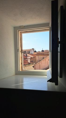 a room with a window with a view of a city at Nije preša apartment 3 in Dubrovnik