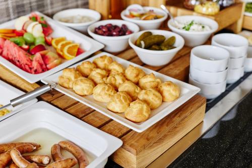 a buffet with plates of food on a table at Pokoje Kameralne in Konopnica