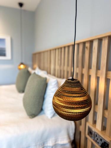 a wicker basket is hanging over a bed at Housel Bay Hotel in Lizard
