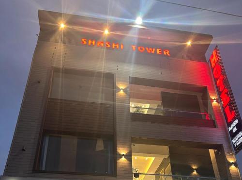 a shash tower building with a sign on it at Hotel platinum inn in Ludhiana