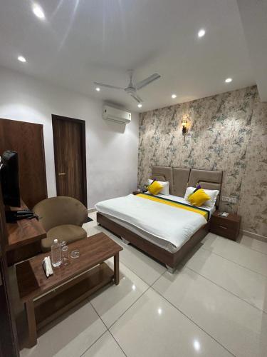 a bedroom with a bed and a couch and a table at Hotel platinum inn in Ludhiana