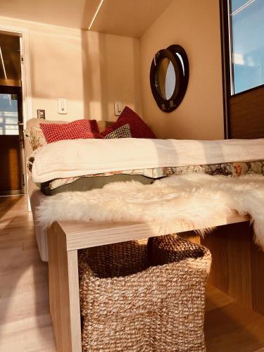a bedroom with two beds and a mirror on the wall at Hausboot Eisvogel in Kirchberg an der Raab
