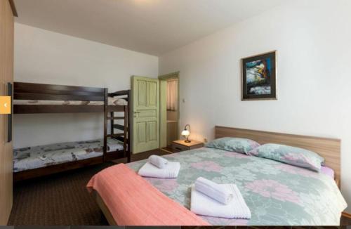 um quarto com uma cama e 2 beliches em Učka nature park mountain hideway robinson house Matić with pool em Brest