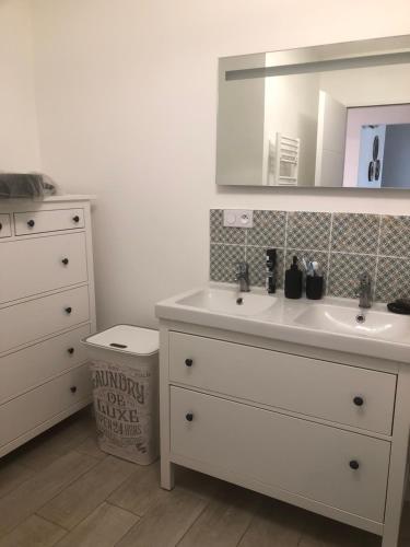 y baño con lavabo blanco y espejo. en La Rose Trémière, en Saint-Pierre-dʼOléron