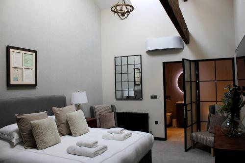 a bedroom with a bed with towels on it at The Merchant's Yard in Tideswell
