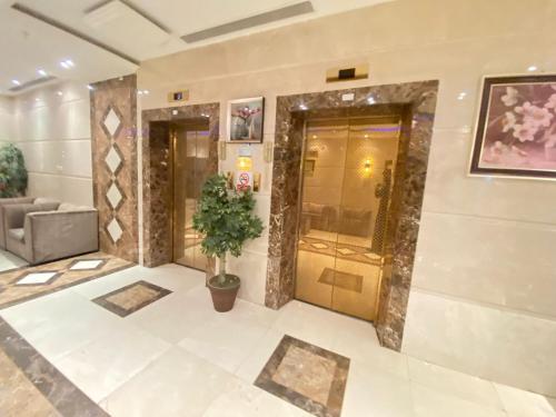 a lobby of a building with a potted plant at مرجان أنوار الروضة in Makkah