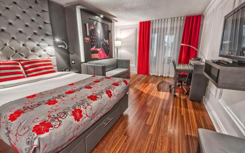 a bedroom with a bed and a desk and a chair at Hotel Plaza Quebec in Quebec City