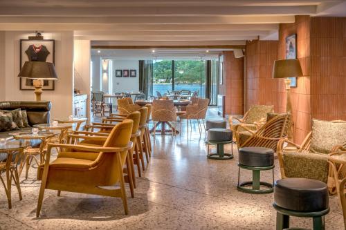 a lobby with chairs and tables and a bar at Harbour Beach Club, Hotel & Spa in Salcombe