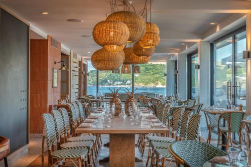 a dining room with a long table and chairs at Harbour Beach Club, Hotel & Spa in Salcombe