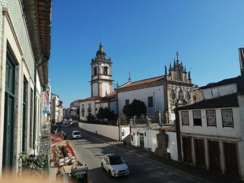 a city street with a clock tower and a church at Guest House Sir Manuel - Unidade São Vicente in Braga