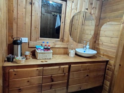 a bathroom with a sink and a mirror at Glamping Paraiso en La montaña in La Calera