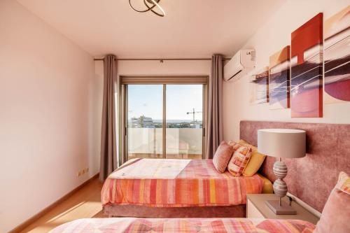 a bedroom with a bed and a window at Breathtaking Coral Ocean View Apartment at OA in Portimão