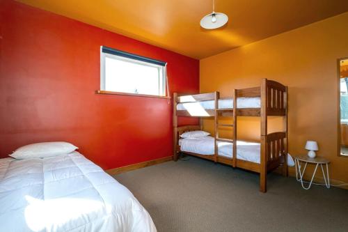 a bedroom with two bunk beds and a window at Forest House Methven in Methven