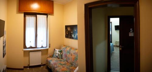 a living room with a couch and a window at Villa Aldo e Lalla in Rozzano