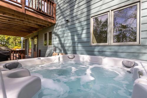 a jacuzzi tub in the backyard of a house at Fox Wood Path Getaway in Galena