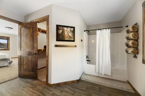 a bathroom with a door leading to a bedroom at THE DEADWOOD DREAM in South Dakota in Sturgis