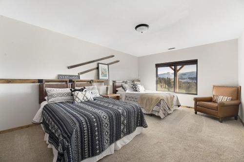 a bedroom with two beds and a chair and a window at THE DEADWOOD DREAM in South Dakota in Sturgis