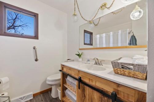 a bathroom with a sink and a toilet at Farmhouse Ranchette - Horses Welcome in Belle Fourche