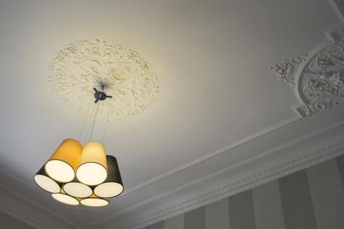 a chandelier hanging from a ceiling in a room at Hotel Grande Italia in Chioggia