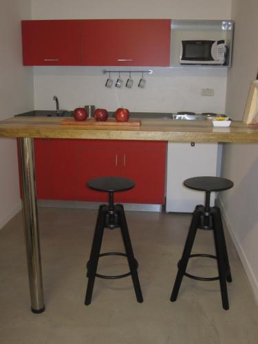 a kitchen with two bar stools and a counter at G38 Rental Apartment Building in Haifa