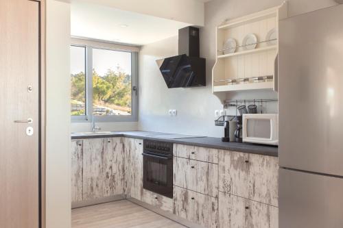 a kitchen with wooden counter tops and a refrigerator at Living Stone - Beryl in Athens