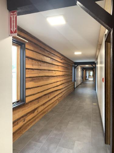 a wooden wall in an office building with a hallway at Bridge Inn Tomahawk - Room 107, 2 Queen Beds, Pet Friendly, Laminate Wood Flooring , Walkout, River View in Tomahawk