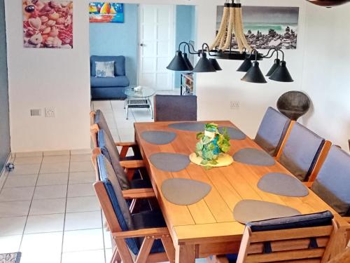 jadalnia z drewnianym stołem i krzesłami w obiekcie Utopia in Palm Beach w mieście Port Edward