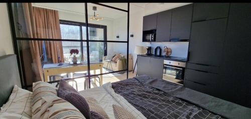 une chambre avec un lit et un salon avec une cuisine dans l'établissement Modern apartment near Tampereen Messukeskus, with own private and free parking, à Tampere