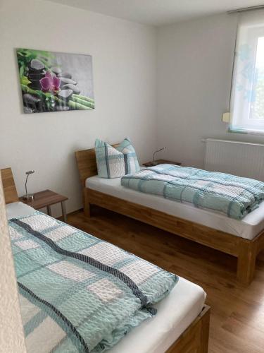 two beds sitting in a room with at Ferienwohnungsvermietung Leitel in Brandenburg an der Havel