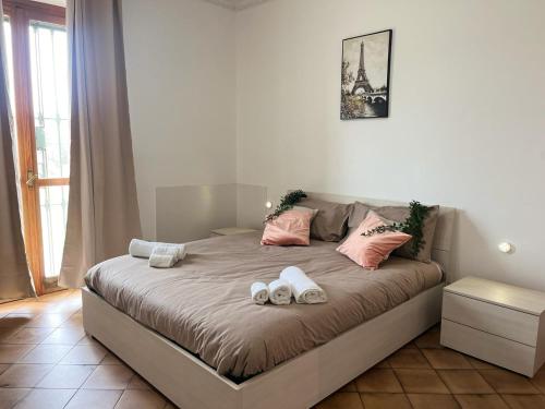 een slaapkamer met een bed met twee schoenen erop bij Modigliani house posizione strategica bilo in Bruino