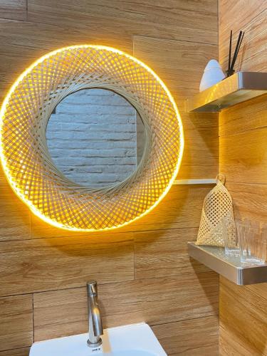 a bathroom with a yellow mirror on the wall at Vui Homestay in Xóm Trương Quít