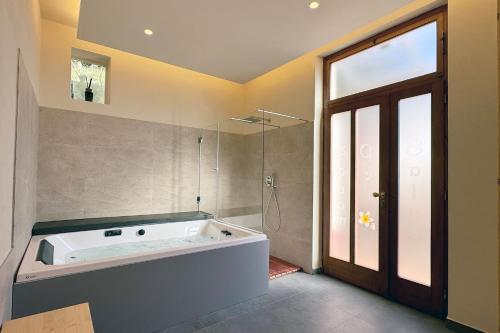 a bath tub in a bathroom with a large window at La Camelia Bianca B&B in Lerici