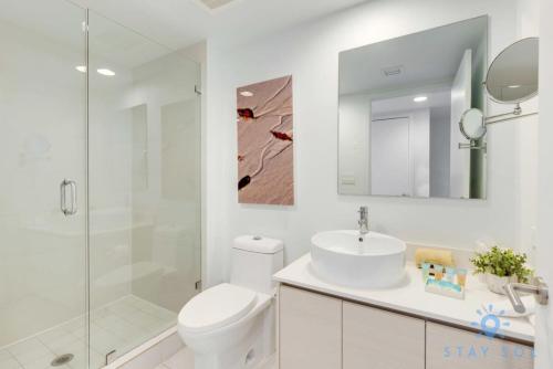 a bathroom with a toilet and a sink and a shower at Balcony - Pool - Near Beach - Gym in Hallandale Beach
