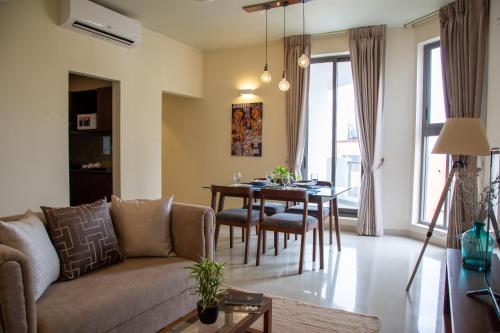 a living room with a couch and a table at Marine Suites in Colombo