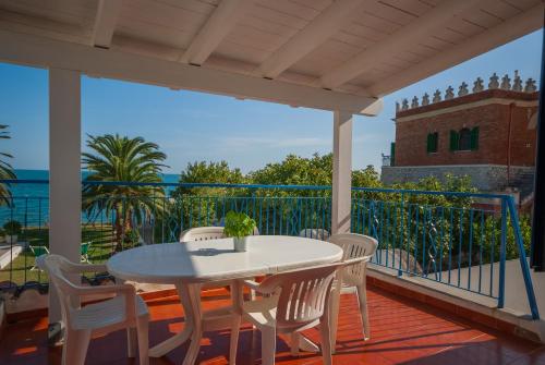 a patio with a table and chairs on a balcony at Villa Lucia in Mattinata