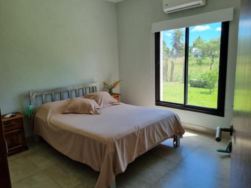 a bedroom with a bed with a large window at Santas Hogar in Santa Ana