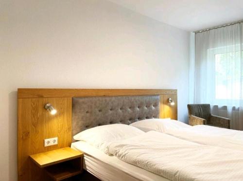 a bedroom with a large bed with a wooden headboard at Herr Berge in Fritzlar
