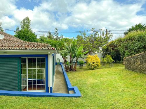 a dog house with a slide in a yard at Casa Tia Néné - Green Glassyard in Lagoa