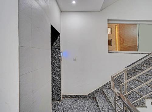 a staircase in a building with a door and a window at Akshay dream stay in Gurgaon