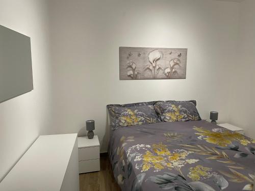 um quarto com uma cama e uma fotografia na parede em Palazzo Rosso em Lesegno