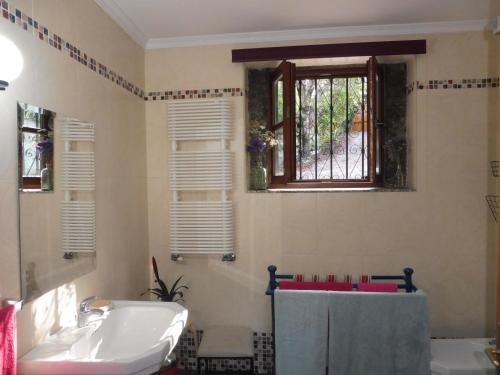 a bathroom with a sink and a window at Quinta da Tapada in Longos