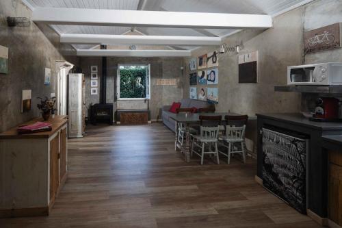 a living room with a couch and a table and chairs at Quinta D'Água in Furnas