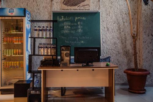 a desk with a chalkboard with a computer on it at Fresh room with a balcony in a digital nomad house in Istanbul