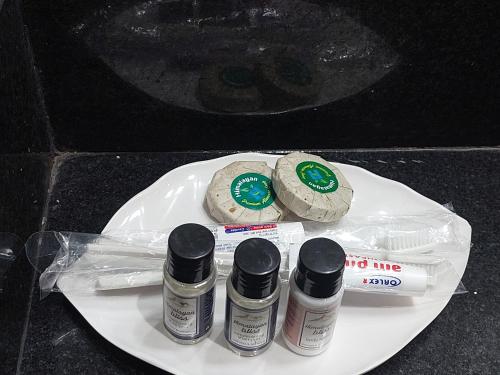 a white plate with three bottles of nail polish at Royal Tiger Luxury Resort in Sauraha