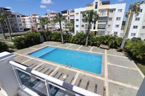 a swimming pool in the middle of a building at 3 BR apartment - READY for your stay WIFI Pool Great Location in Santiago de los Caballeros