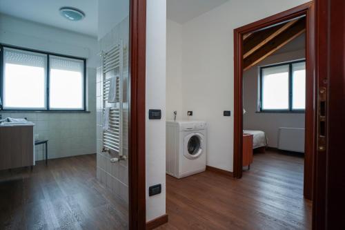a bathroom with a washing machine in a room at Bnbook Expo Residence Rho in Rho