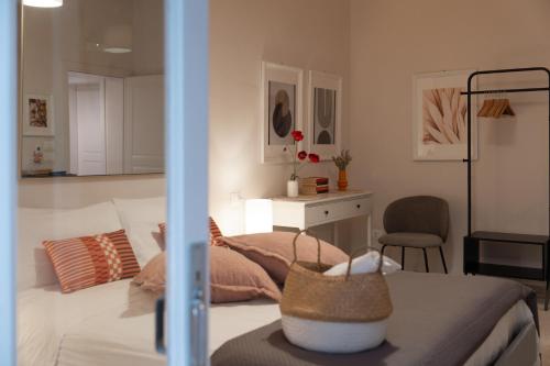 a bedroom with a bed and a desk and a chair at Palazzo Marzionna in Polignano a Mare